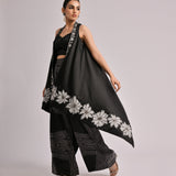 Black Assymetrical Long Jacket Paired With A Solid Pleated Bustier And Printed Pants